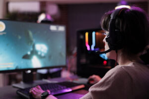young streamer playing video games online live stream using computer neon lights living room female gamer having fun with action gameplay virtual shooting tournament